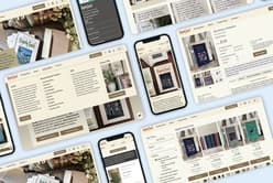 The image displays a collection of digital device screens showcasing the website for "Slightly Foxed," a literary magazine and book retailer. The layout features various sections including subscriptions, gifts, and a catalogue of books. One screen prominently displays a book titled "The Road to Waterloo" by Ronald Welch, priced at £16. Another screen highlights a collection of books with colourful covers. The background includes a textured surface with books, flowers, and stationery items, suggesting a cosy reading environment.