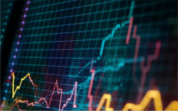 The image displays a close-up view of a digital financial graph on a dark background. The graph features multiple lines in vibrant colours, including yellow, orange, pink, and blue, representing different data trends over time. The grid layout is visible, marked by horizontal and vertical lines, providing a clear structure. Data points are highlighted along the lines, indicating fluctuations in values. The overall composition conveys a sense of dynamic movement and analysis, typical of financial or market data visualisations.