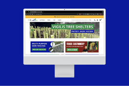 A computer monitor displays a website featuring various products for gardening and landscaping. The top banner highlights "Vigilis Tree Shelters" with a tagline of "Protect, Grow, Sustain." Below, there are sections for "Multi-Purpose Wire Fencing" and an invitation for trade customers to open an account. The background is a solid blue.