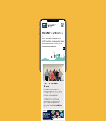 A smartphone displays a webpage for the North Essex Economic Board on a bright yellow background. The top section features the NEEB logo, which includes the letters 'N', 'E', and 'B' in a stylised format, alongside the text "North Essex Economic Board." Below, there is a heading, "Help for your business," followed by a brief description of support available for businesses. The lower part of the screen shows a group photo of five people standing together, smiling, with varied attire