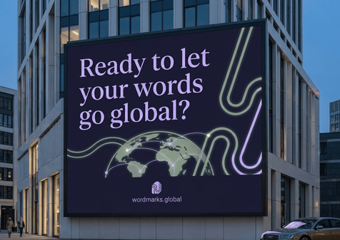 Mockup of a billboard for Word Marks, a fictional brand created for this case study, on the side of an office building at dusk. The headline reads "Ready to let your words go global?" in lilac serif type on navy. Below, green and lilac curved lines flow around a globe with connection points linking continents. The Word Marks logo and the web address wordmarks.global sit at the bottom.