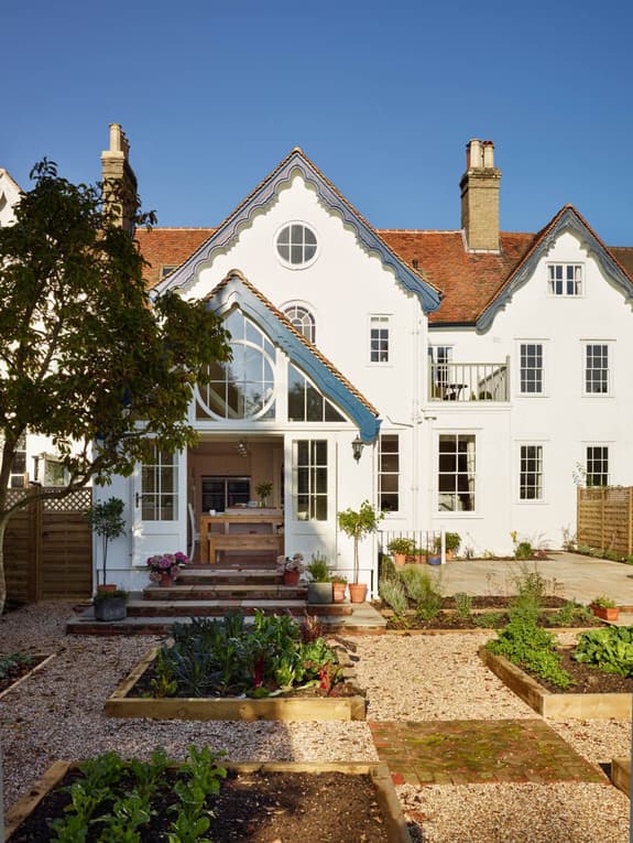 The back of the house that is the Green Apron cookery school, sowing open doors into the kitchen and raised beds in the garden.