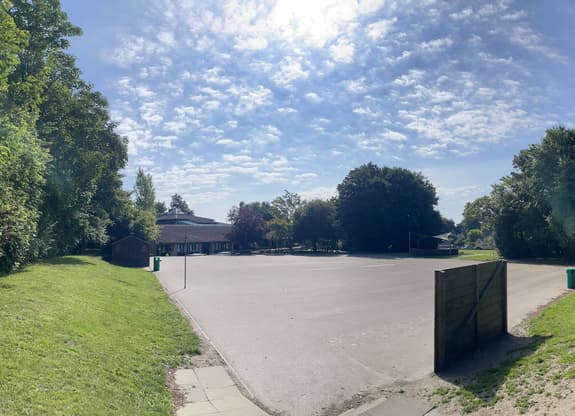 a panaromic shot of a school playground with a blue sky above