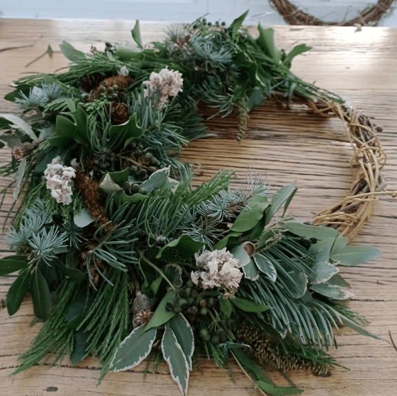 A wreath being created on a table