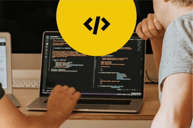 Two developers working on code on a laptop with a large yellow circle at the top containing a greater than sign, backslash and less than sign
