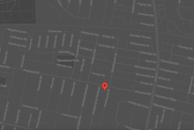 A screenshot of Google Maps in dark mode with a red location pin on a road called Westbourne Street