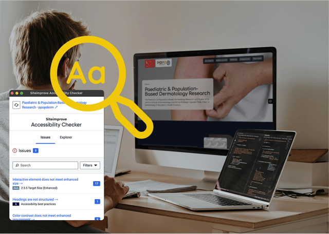 A person is sitting at a desk, facing a laptop and a large computer monitor. The screen displays a website titled "Paediatric & Population-Based Dermatology Research." An overlay shows a magnifying glass icon with the text "Accessibility Checker" and a list of digital accessibility issues, including a count of five issues. The workspace is tidy, with coding visible on the laptop screen and a notepad nearby.