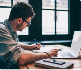 Man writing with laptop