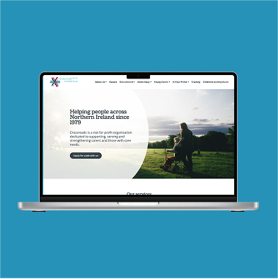 A blue background with a laptop showing a website for Crossroads Care Northern Ireland.