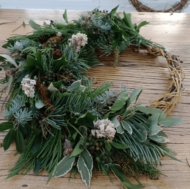 A wreath being created on a table